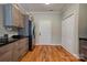 Bright kitchen features wood floors, granite countertops, modern cabinets and stainless steel refrigerator at 1529 Alex Dr, Shelby, NC 28152