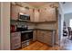Modern kitchen with stainless steel appliances, wooden cabinets, and granite countertops at 1529 Alex Dr, Shelby, NC 28152