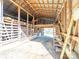 Inside view of a barn with a wooden structure and multiple levels with stairs at 17118 Frog Pond Rd, Oakboro, NC 28129