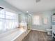 Bright bathroom featuring a glass shower, soaking tub, and updated tile flooring at 17118 Frog Pond Rd, Oakboro, NC 28129