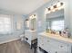 Bathroom featuring dual sinks, great natural light, modern vanities, and updated tile flooring at 17118 Frog Pond Rd, Oakboro, NC 28129