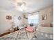 Bedroom featuring hardwood floors, a ceiling fan, crib and a sofa at 17118 Frog Pond Rd, Oakboro, NC 28129