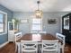 Cozy dining area with a wooden table, white chairs, and neutral wall color at 17118 Frog Pond Rd, Oakboro, NC 28129