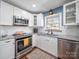 Well-equipped kitchen with stainless steel appliances, granite counters, and ample cabinet space at 17118 Frog Pond Rd, Oakboro, NC 28129