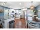 Modern kitchen featuring white cabinets, stainless steel appliances, and a dining area at 17118 Frog Pond Rd, Oakboro, NC 28129