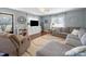 Bright living room featuring hardwood floors, neutral paint, large windows and comfortable seating at 17118 Frog Pond Rd, Oakboro, NC 28129
