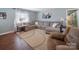 Inviting living room with hardwood floors, ample natural light, and a comfortable sectional sofa at 17118 Frog Pond Rd, Oakboro, NC 28129