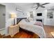 Serene main bedroom features a ceiling fan, fireplace, hardwood floors, and a cozy ambiance at 17118 Frog Pond Rd, Oakboro, NC 28129