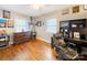 Home office space boasts hardwood floors, a ceiling fan, and built-in shelving and drawers at 17118 Frog Pond Rd, Oakboro, NC 28129