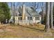 Backyard view showing a wooden deck with white railing and mature trees around the property at 2001 Tanfield Dr, Matthews, NC 28105