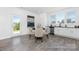 Cozy dining area with wood-look floors, a glass table, stainless appliances, and ample natural light at 219 Tillery Ln # 754P, Mount Gilead, NC 27306
