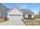 Charming single-story home with white siding, a two-car garage and a manicured front yard at 219 Tillery Ln # 754P, Mount Gilead, NC 27306