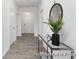 Inviting hallway featuring wood-look flooring, a console table, and ample lighting at 219 Tillery Ln # 754P, Mount Gilead, NC 27306