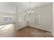 Dining area featuring modern chandelier, wood flooring, and natural light at 219 Tillery Ln # 755P, Mount Gilead, NC 27306