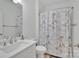 Neat bathroom featuring a white sink, toilet, and a shower curtain with Paris and postal themes at 293 Blanche Cir, Rock Hill, SC 29730