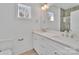 Bright bathroom featuring a double sink vanity, quartz countertop, and a window providing natural light at 293 Blanche Cir, Rock Hill, SC 29730