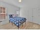 Cozy bedroom with a patterned comforter, wood floors, and natural light from two windows at 293 Blanche Cir, Rock Hill, SC 29730