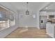 Well-lit dining area with ample windows, modern lighting, and an adjacent stainless steel refrigerator at 293 Blanche Cir, Rock Hill, SC 29730