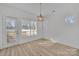 Well-lit dining area with a modern light fixture and large windows offering natural light at 293 Blanche Cir, Rock Hill, SC 29730