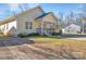 Inviting yellow home with a covered porch and tidy landscaping enhances its curb appeal at 293 Blanche Cir, Rock Hill, SC 29730