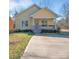 Charming yellow cottage with a cozy front porch and well-manicured lawn on a sunny day at 293 Blanche Cir, Rock Hill, SC 29730