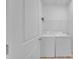 Well-lit laundry room with a white washer and dryer, wire shelving, and a door ajar at 293 Blanche Cir, Rock Hill, SC 29730