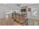 Bright living room with a stone fireplace, modern ceiling fan, and cozy leather seating at 293 Blanche Cir, Rock Hill, SC 29730