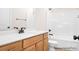 Bathroom features a shower over tub and single sink vanity with light wood cabinets and bronze hardware at 338 Shinnville Rd, Mooresville, NC 28115