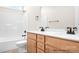 Bathroom features a shower over tub and a double sink vanity with light wood cabinets and bronze hardware at 338 Shinnville Rd, Mooresville, NC 28115