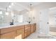 Elegant bathroom with dual vanities, wood cabinetry, and a separate shower area at 338 Shinnville Rd, Mooresville, NC 28115