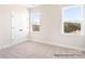 Bright bedroom with two windows providing natural light and a spacious closet with double doors at 338 Shinnville Rd, Mooresville, NC 28115