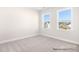 Cozy bedroom features neutral carpet, natural light, and two windows with neighborhood views at 338 Shinnville Rd, Mooresville, NC 28115