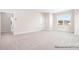 Spacious bonus room with neutral carpet and a large window, perfect for a playroom or home office at 338 Shinnville Rd, Mooresville, NC 28115