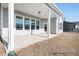 A covered porch with white columns and a concrete floor creates an inviting outdoor space at this new home at 338 Shinnville Rd, Mooresville, NC 28115