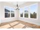 Charming dining area with hardwood floors, large windows, and an elegant chandelier at 338 Shinnville Rd, Mooresville, NC 28115