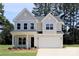 Charming two-story home featuring a two-car garage and a beautifully maintained front yard at 338 Shinnville Rd, Mooresville, NC 28115