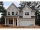 Two-story home with a two car garage, board and batten siding and a covered front porch with columns at 338 Shinnville Rd, Mooresville, NC 28115