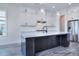 Modern kitchen features stainless steel appliances, a large island, and elegant pendant lighting at 338 Shinnville Rd, Mooresville, NC 28115