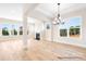 Bright and open living space featuring a fireplace, large windows, and hardwood flooring at 338 Shinnville Rd, Mooresville, NC 28115