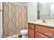 Well-maintained bathroom with a vanity, a toilet, and a shower with a patterned curtain at 4118 Caldwell Ridge Pkwy, Charlotte, NC 28213