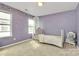 Charming bedroom with light purple walls, a decorative canopy, and abundant natural light at 4118 Caldwell Ridge Pkwy, Charlotte, NC 28213