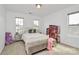 Charming bedroom with a cozy bed, a stylish bench, and a delightful dollhouse display at 4118 Caldwell Ridge Pkwy, Charlotte, NC 28213