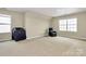 Spacious bedroom featuring neutral walls, plush carpet, and natural light from a large window at 4118 Caldwell Ridge Pkwy, Charlotte, NC 28213