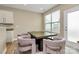 Bright dining area with large window and exterior door, furnished with a modern table and unique chairs at 4118 Caldwell Ridge Pkwy, Charlotte, NC 28213