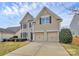 Charming two-story home with a well-manicured lawn and a two-car garage at 4118 Caldwell Ridge Pkwy, Charlotte, NC 28213