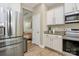 Well-equipped kitchen featuring stainless steel appliances, granite countertops, and stylish white cabinets at 4118 Caldwell Ridge Pkwy, Charlotte, NC 28213