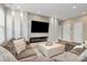 Bright living room featuring a modern fireplace, a large television, and a comfortable sectional sofa at 4118 Caldwell Ridge Pkwy, Charlotte, NC 28213
