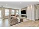 Inviting living room with a cozy sectional sofa, a stylish fireplace, and ample natural light at 4118 Caldwell Ridge Pkwy, Charlotte, NC 28213