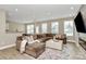Spacious living room featuring a comfortable sectional, contemporary decor, and large windows for natural light at 4118 Caldwell Ridge Pkwy, Charlotte, NC 28213