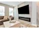 Modern living room with built-in fireplace and large flat-screen TV at 4118 Caldwell Ridge Pkwy, Charlotte, NC 28213